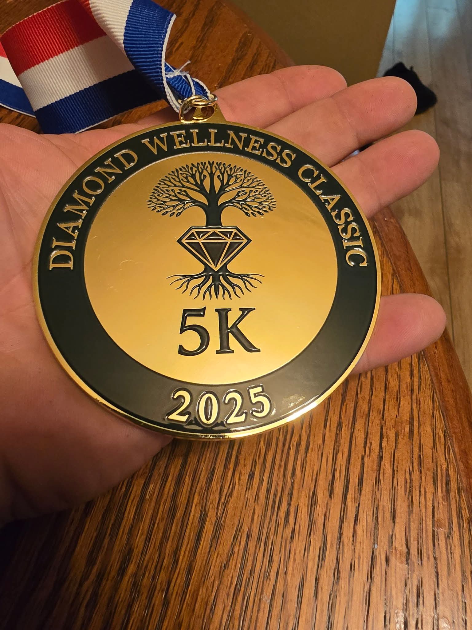 A Diamond Wellness Classic 5K medal.